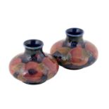 William Moorcroft (1872-1945): A Pair of Pomegranate Pattern Squat Vases, on blue grounds, blue