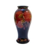 William Moorcroft (1872-1945): A Pomegranate Pattern Baluster Vase, on a blue ground, green