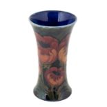 William Moorcroft (1872-1945): A Big Poppy Pattern Trumpet Vase, circa 1925, on a dark blue