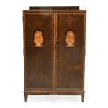 An Art Deco Inlaid Oak Cupboard, circa 1925, with inlaid upstand, above two doors with floral
