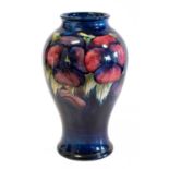 William Moorcroft (1872-1945): A Pansy Pattern Vase, circa 1930s, on a dark blue ground, impressed