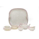 A Belleek Porcelain Tête-à-Tête, 19th century, shell moulded, edged in gilt and blush pink, black