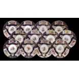 A Set of Twelve Derby Porcelain Dinner Plates, circa 1820, painted with flower sprays and insects on