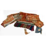 19th Century and Later Chinese Embroideries comprising red silk embroidered lower robe remnants