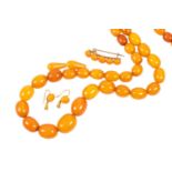 A Graduated Amber Bead Necklace, length 74cm (approximately); An Amber Bead Brooch, length 4.1cm;