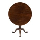 A George III Mahogany Circular Tripod Table, circa 1780, the one-piece top on a birdcage platform