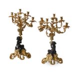 A Pair of French Gilt and Patinated Bronze Eight-Light Figural Candelabra, in Louis XV style, with