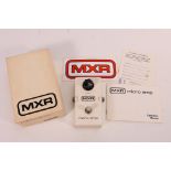 A boxed MXR Micro-Amp guitar pedal.