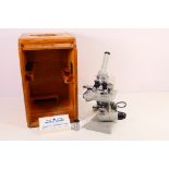 A vintage Carl Zeiss - Jena microscope contained in tambour front wooden case.