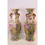 A large pair of Chinese vases with floral decoration against a yellow ground,