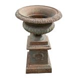 Pair of ornate cast metal garden urns, 84cm high.