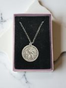 A silver medallion depicting St. Christopher on a silver belcher chain.
