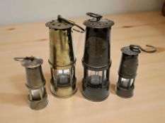 Four miniature miner's lamps
