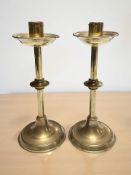 A pair of brass candlesticks with knopped stems,