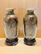 A pair of Japanese cloisonne vases, on turned wooden stands,