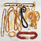 A multi-strand coral necklace and a collection of amber or amber-type necklaces, bracelets,