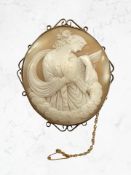 A good quality large cameo brooch depicting Hebe feeding Zeus as an eagle, mounted in yellow metal,