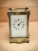 A brass carriage timepiece with key,