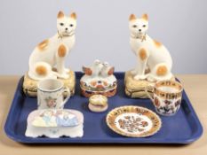 A group of ceramic ornaments to include a pair of cat figures on cushions, storage box,