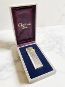A Christian Dior silver and gold-plated gas lighter, engraved with initials RJW to top,