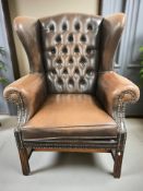 A late 20th century Chesterfield wingback armchair,