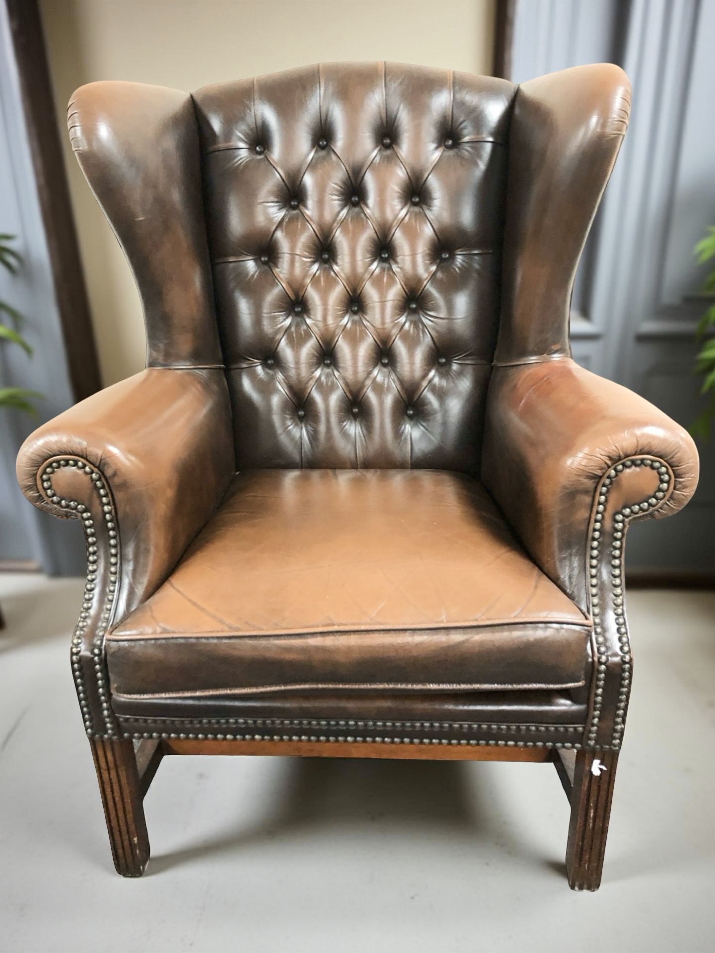 A late 20th century Chesterfield wingback armchair,