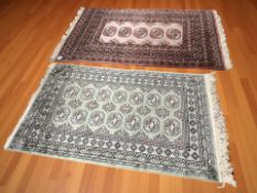 A Lahore Bokhara rug, Pakistan, 131 cm x 79 cm, together with another similar rug.
