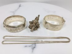 A Victorian child's rattle (missing base), together with two engraved bangles and a silver chain.