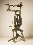 A brass model of a spinning wheel, height 52 cm.