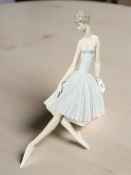 A Lladro figure of a ballerina seated on a plinth, height 36 cm.