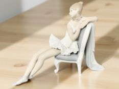A Lladro figure of a ballerina seated on a chair, height 25 cm.