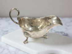 A Victorian silver cream jug, Robert Waddington, Chester 1896, length 13cm.
