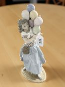 A Lladro figure of a girl holding balloons, height 26 cm.