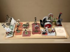 A group of Mamod steam engine components mounted on an oak board, length 71 cm,