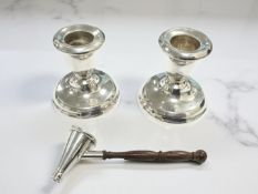 A pair of loaded-silver dwarf candlesticks, height 5.5cm, and a modern silver candle snuff.