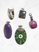 Four Continental white metal / silver mounted pendants and a further dog brooch,