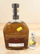 A 700ml bottle of Woodford Reserve Kentucky Straight Bourbon whiskey and a 50ml bottle of Absolut