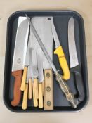 A group of chef's knives including a large cleaver stamped John Petty & Sons,