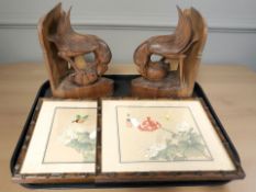 A pair of carved wooden bookends in the form of birds,