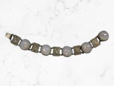 A Continental white metal bracelet with panels depicting monkeys and synthetic opal,
