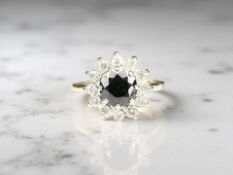 An 18ct yellow gold sapphire and diamond cluster ring, size L/M. CONDITION REPORT: 4.