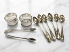 A set of six silver teaspoons, a pair of tongs,