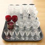 A set of six Edinburgh Crystal wine glasses and various other drinking glasses.