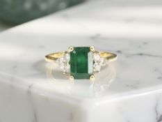 An 18ct gold emerald and diamond ring, size L CONDITION REPORT: 2.