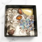 A collection of modern designer silver jewellery, hard stone pendants,