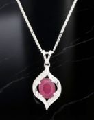 An 18ct white gold ruby and diamond pendant, the oval ruby approximately 2.