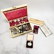 A jewellery box containing assorted silver and costume jewellery,