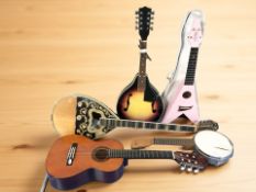A group of stringed instruments including mandolins, banjo, small guitar, etc.
