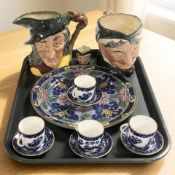 A set of four Coalport blue and white gilt rimmed coffee cups and matching saucers,