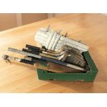 A group of vintage tennis rackets, cricket bats and other equipment.